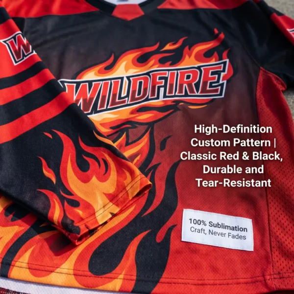 Close-up of red and black hockey jersey chest detail showcasing vibrant flame pattern and team name via 100% sublimation printing—no wrinkles, fade-resistant—with mesh breathable texture highlighted and text "100% Sublimation Craft, Never Fades | High-Def Custom Pattern, Durable Red-Black Colors".